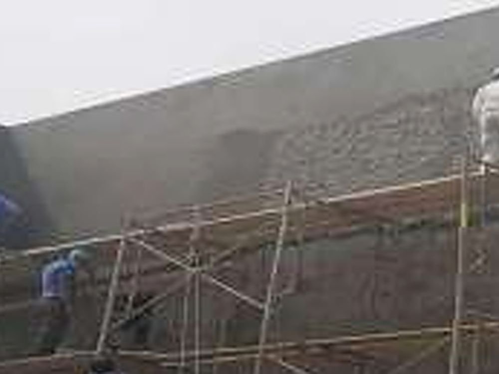 Stone paint being applied to a facade